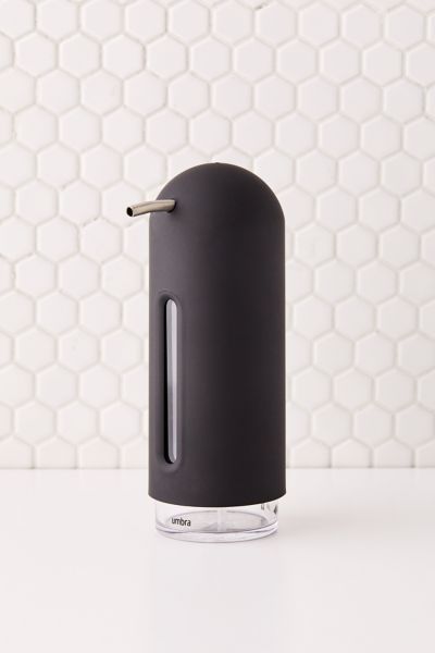 an electronic device is sitting on the counter in front of a white tile wall with hexagonal tiles