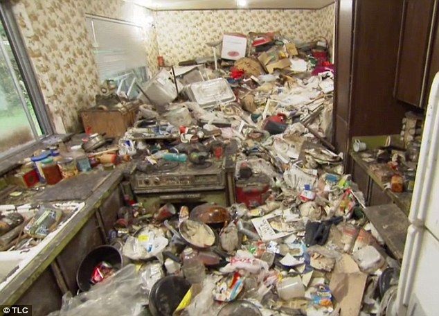 a kitchen filled with lots of trash next to a refrigerator