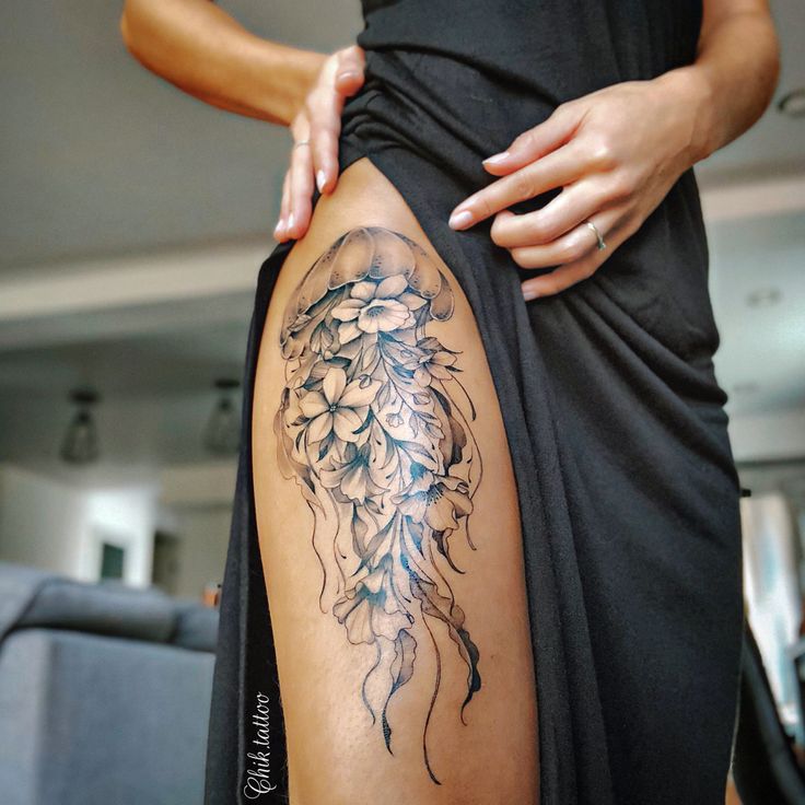 a woman with a tattoo on her thigh