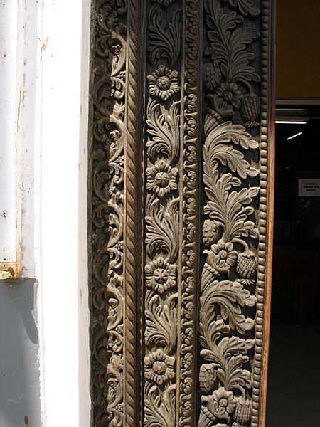 an intricately carved wooden door is open