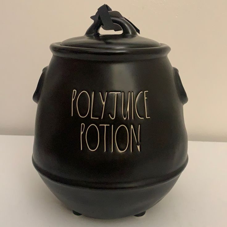 a black pot with writing on it that says polytytuce potterton in gold lettering