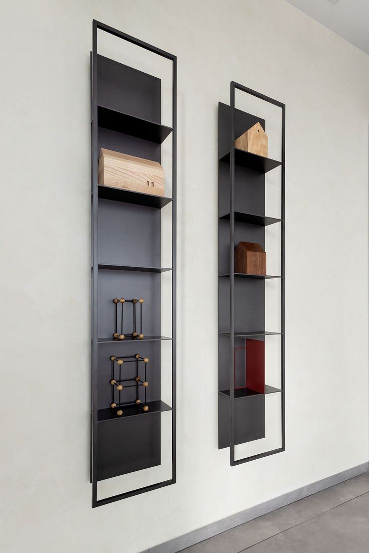 two black shelves with wooden boxes on them