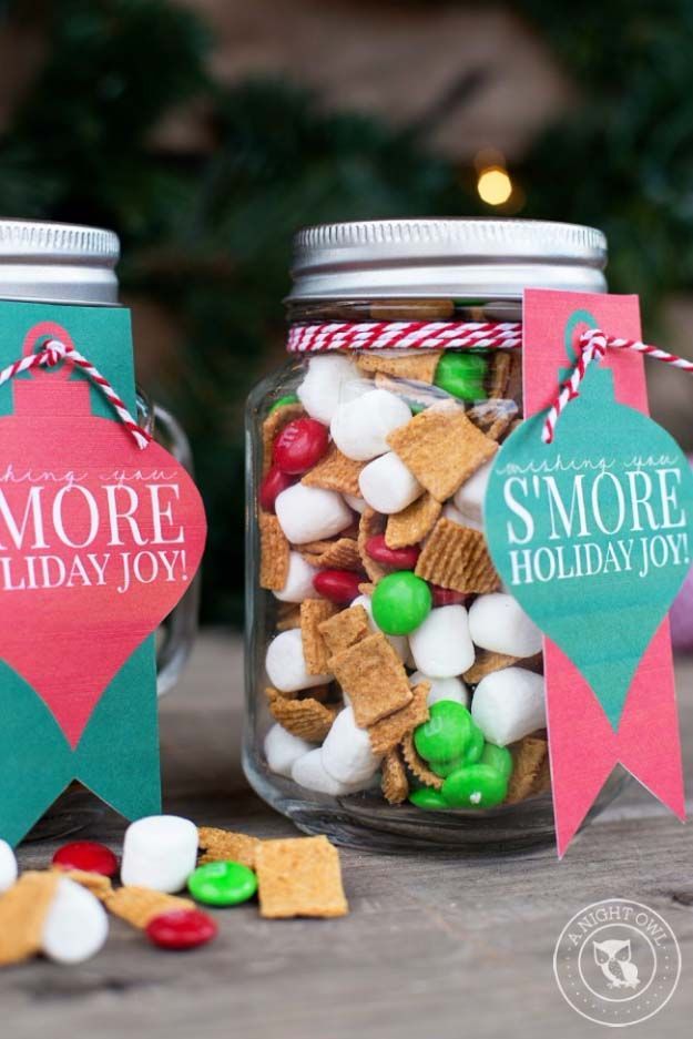 two mason jars filled with holiday treats on top of a table