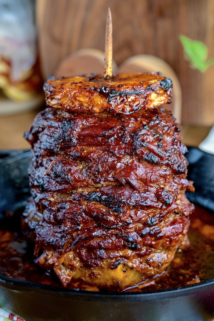 a stack of ribs sitting on top of a frying pan covered in bbq sauce