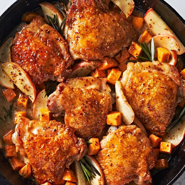 chicken and potatoes in a skillet with rosemary