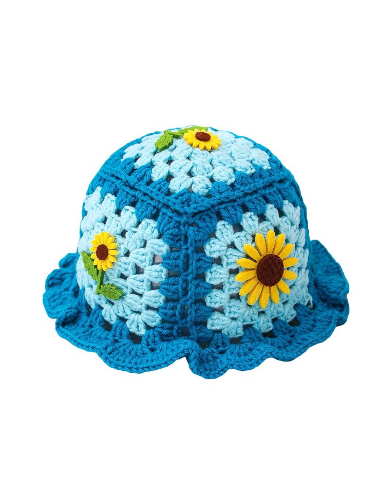 a crocheted blue hat with sunflowers on it