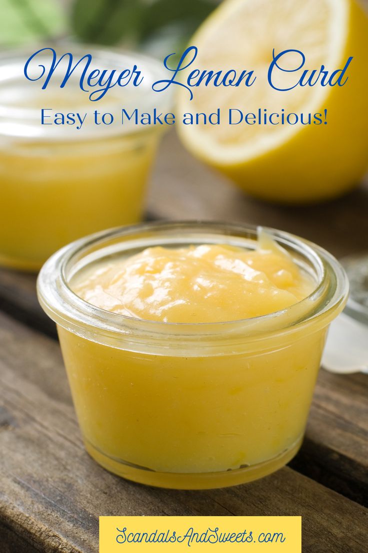 a jar filled with lemon curd sitting on top of a wooden table