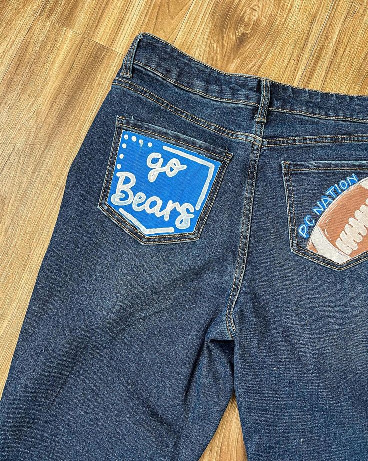 Looking for painted jeans? I am now doing customizable jeans!🩵🫶🏼🤪 #jeans #paintedjeans #art #paint #seniorjeans #smallbusiness Homecoming Painted Jeans Ideas Diy, Painting Jeans For Homecoming, Painted Jeans For Football Games, School Jeans Painted, Homecoming Painted Jeans, Hoco Jeans Painted Ideas, Hoco Painted Jeans, Spirt Jeans, Homecoming Jeans Painted