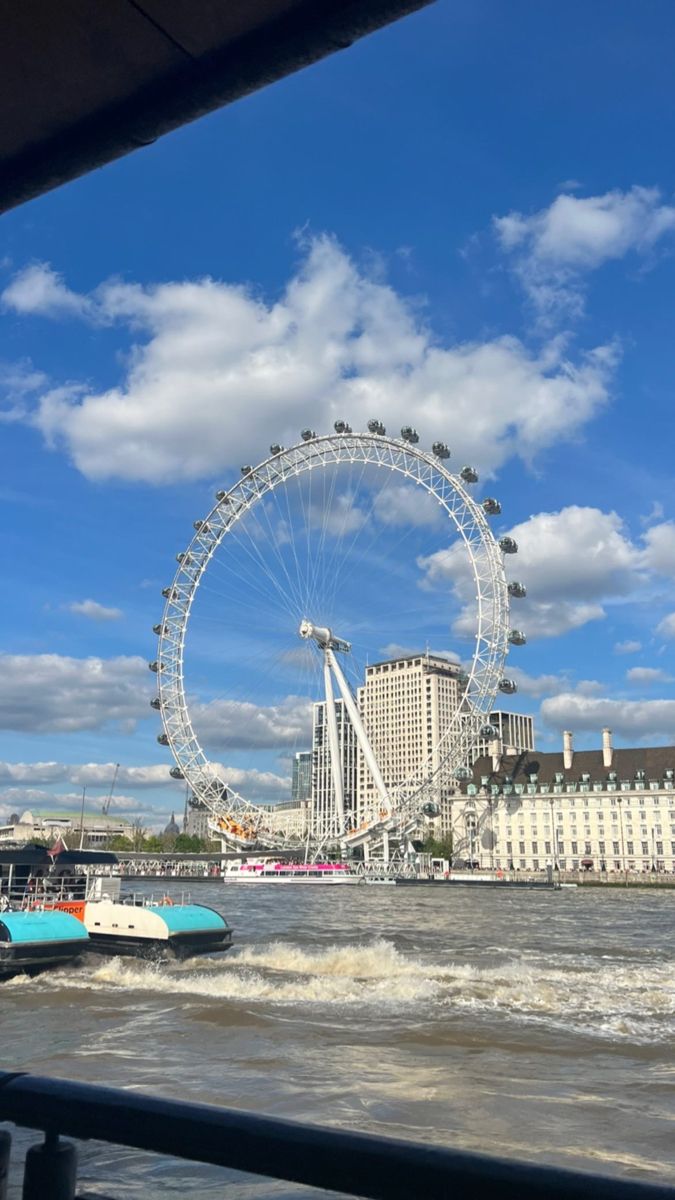 the london eye ferris wheel is seen from across the river