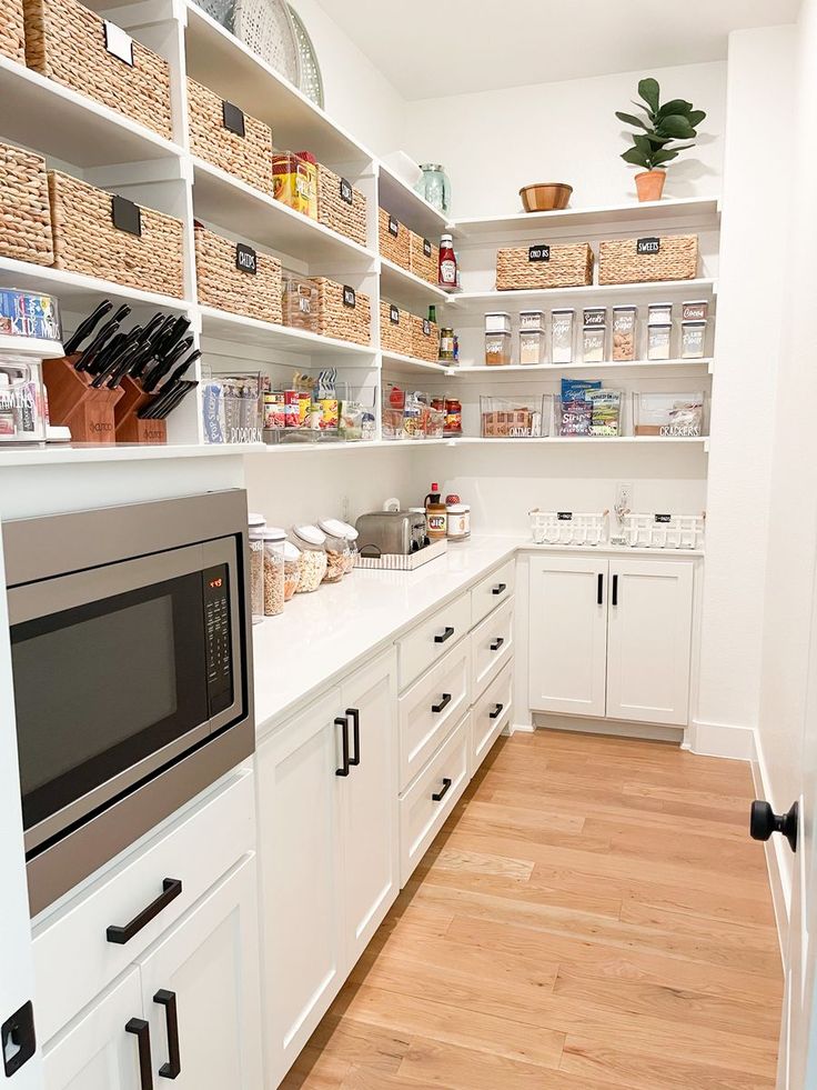 the kitchen is clean and ready for us to use it's shelves are filled with food