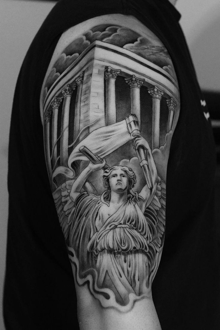 the back of a man's arm with an image of two women holding torches