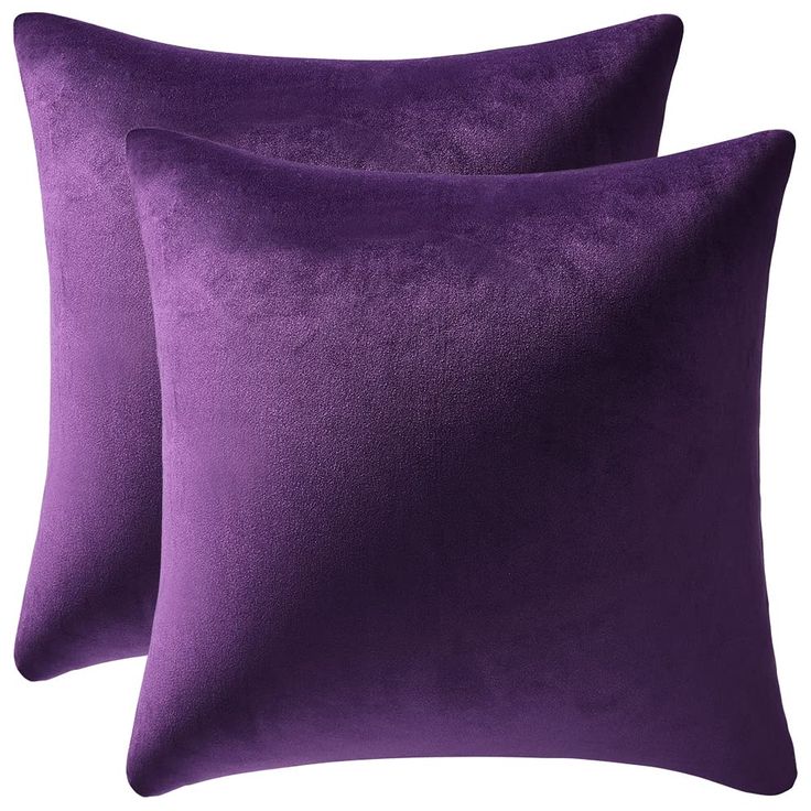 two purple pillows sitting on top of each other