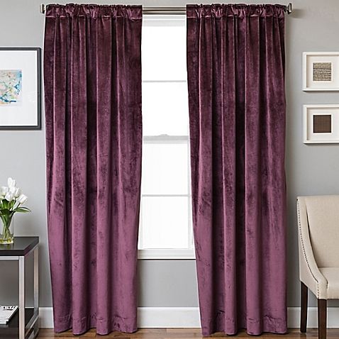 a living room with purple curtains and a chair