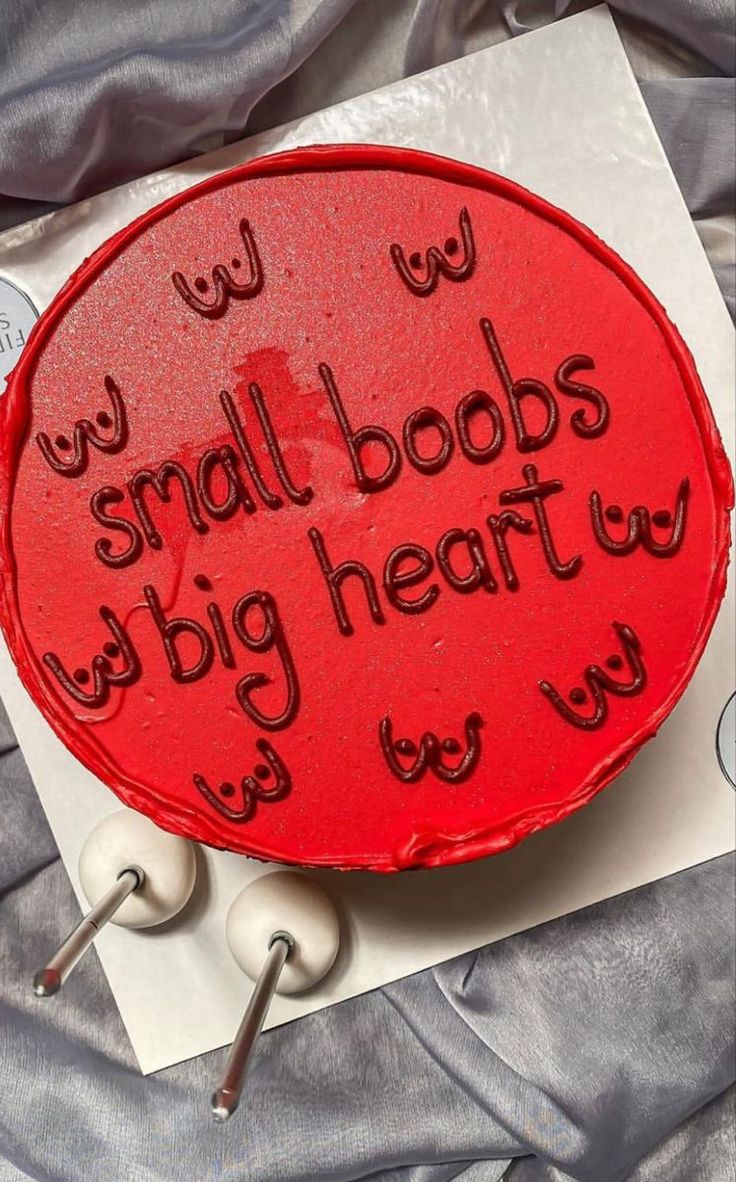 a red cake with writing on it that says small boos big heart