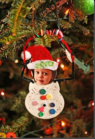 a child's christmas ornament hanging from a tree