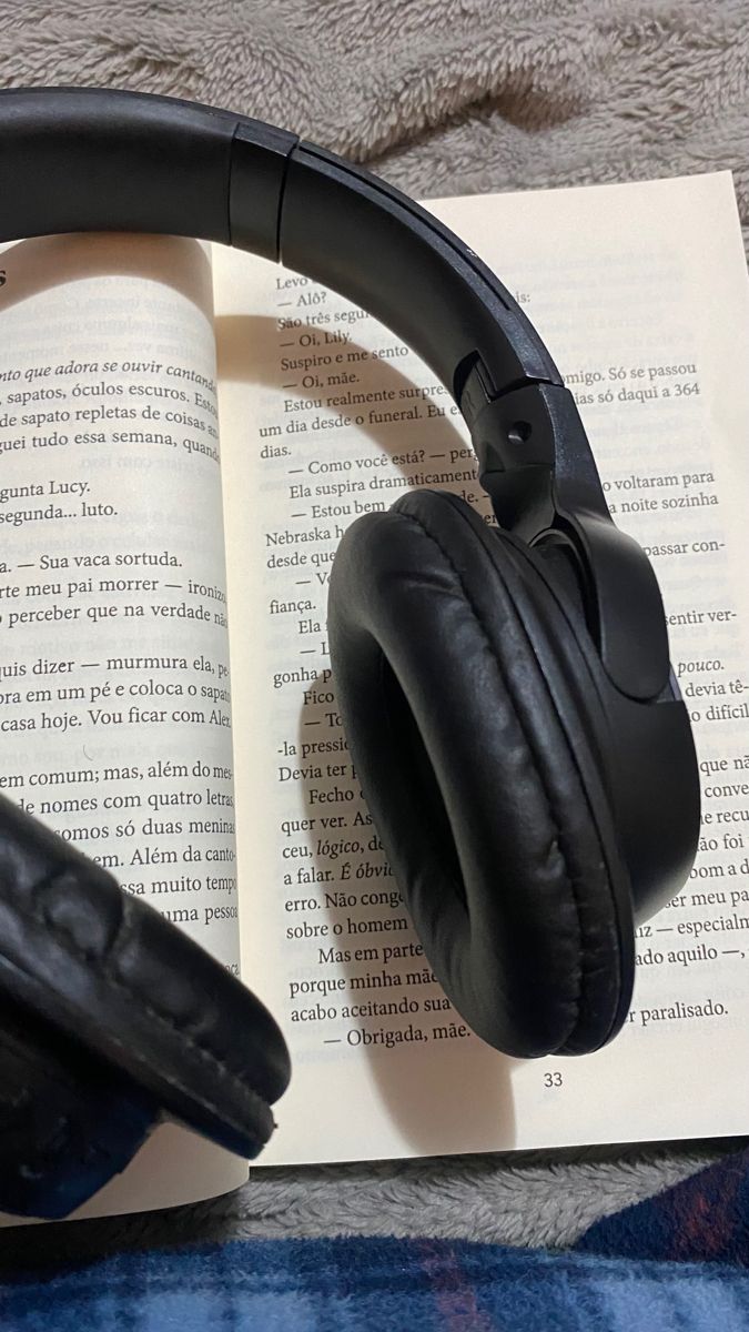 headphones resting on top of an open book