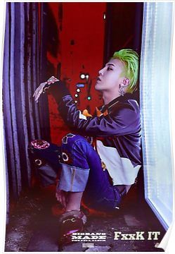 a woman with green hair sitting on the ground in front of a door and looking up