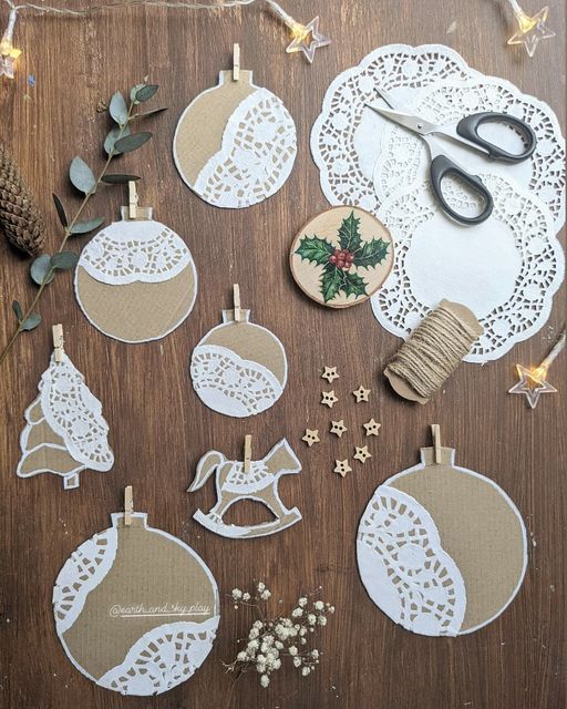 christmas ornaments are displayed on a table with scissors and other crafting supplies around them