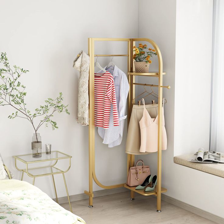 a clothes rack in the corner of a room with shoes and purses on it