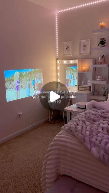 a bed room with a neatly made bed and a flat screen tv on the wall