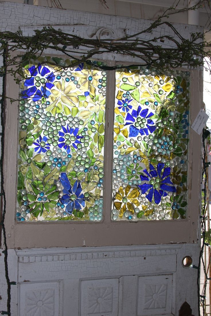 an old door with stained glass flowers on it