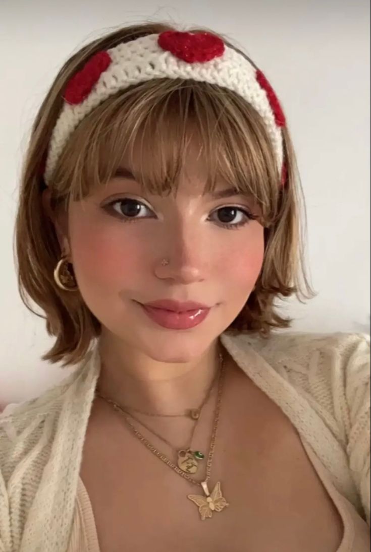 a woman wearing a headband with hearts on it