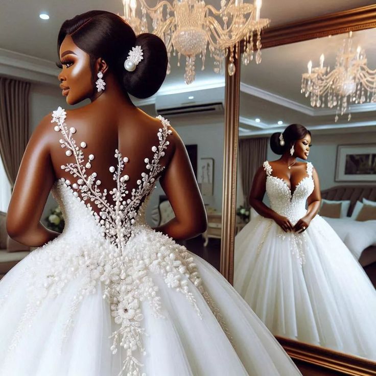 a woman in a wedding dress looking at herself in the mirror with her back to the camera