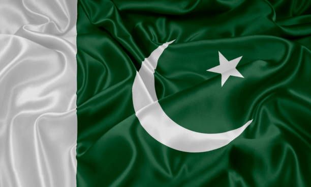 the flag of pakistan is waving in the wind, with silky fabric covering it's surface