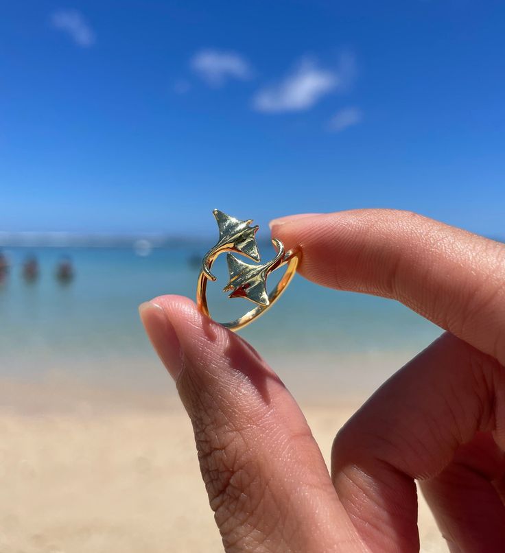 This ring, part of the Au'au Channel Whales Collection, is crafted from high-quality 925 sterling silver and features a pair of twin sterling silver manta rays.  The Au'au Channel, meaning "taking a bath," is a body of water located between the islands of Maui and Lanai. Known for its calm waters, it serves as a refuge in the Pacific Ocean and a mating ground for humpback whales. The channel is also home to graceful manta rays, often seen roaming around its shallow, tranquil waters. This adjusta Luxury Ocean-inspired Rings For Gift, Ocean Gold Ring, Ocean Rings, Marine Jewelry, Manta Rays, Surf Jewelry, Beachy Jewelry, Preppy Jewelry, Calm Waters