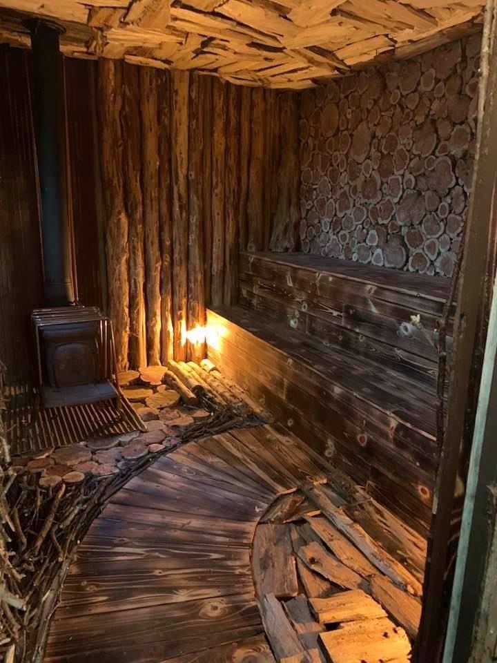 an old room with wooden walls and flooring is lit by the light of a candle