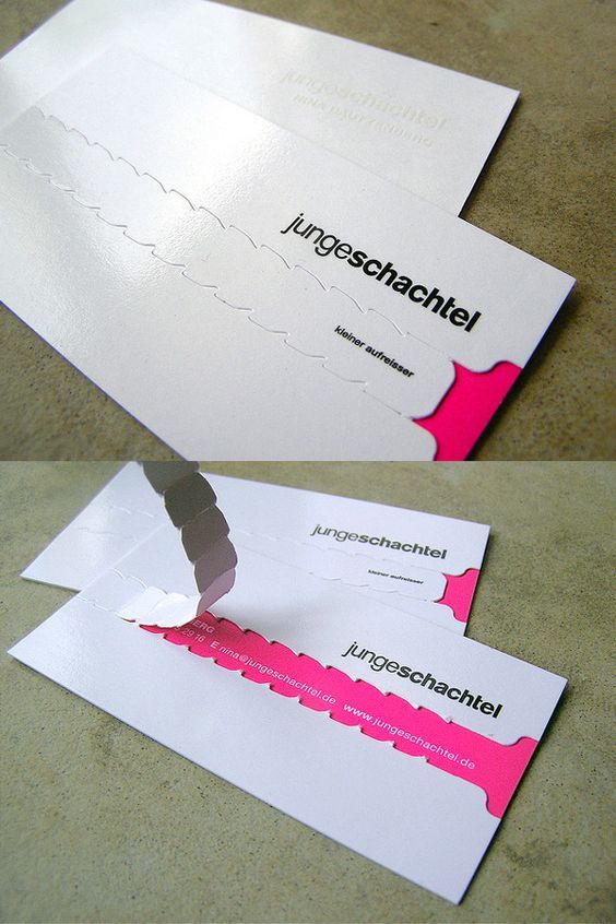 two pieces of white paper with pink and black designs on them, one has a hole in the middle