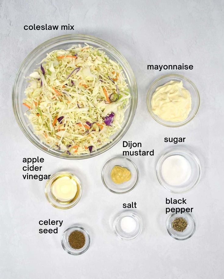 ingredients to make coleslaw in bowls on a white surface with words describing the ingredients