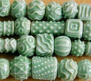 some green and white beads on a table