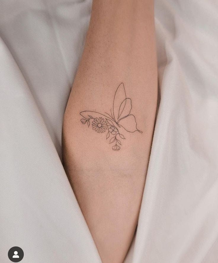 a woman's foot with a butterfly tattoo on it