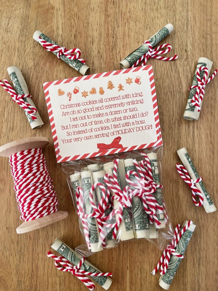 red and white candy canes are on the table next to a spool of twine