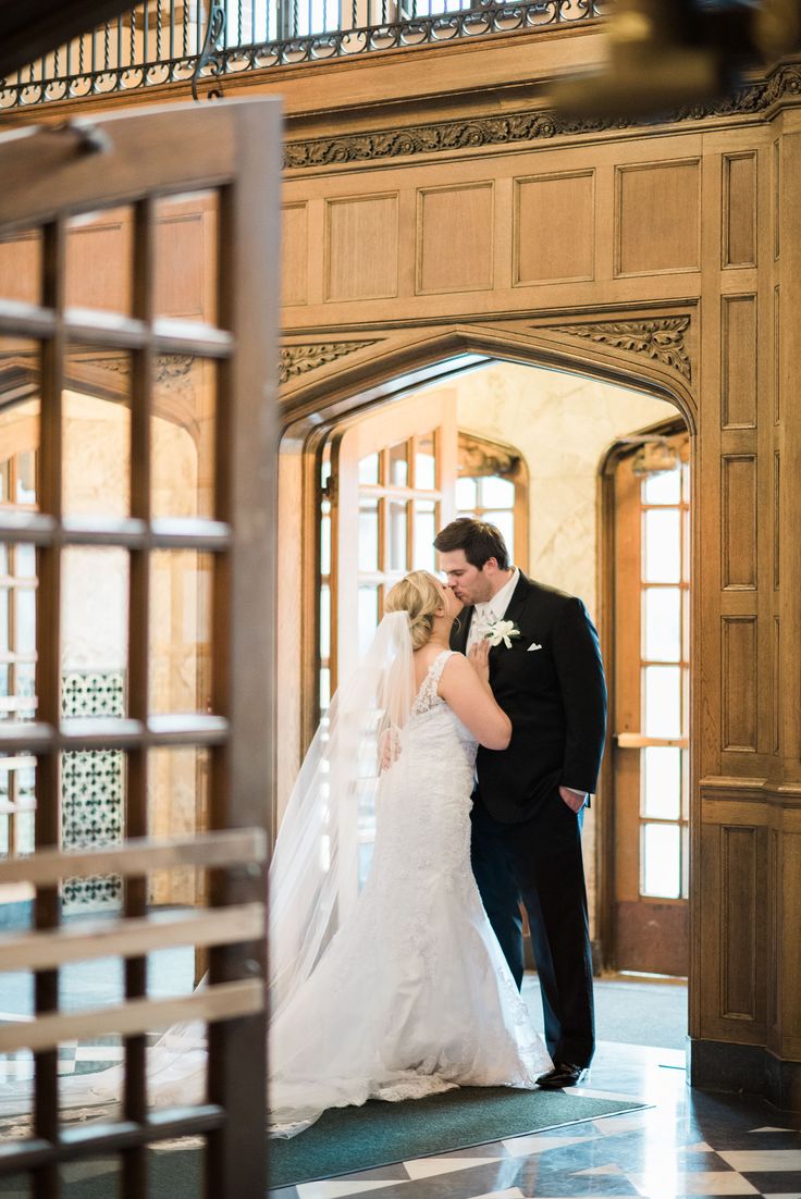 a bride and groom standing in an archway