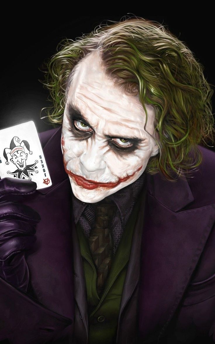 the joker holding a playing card in his hand