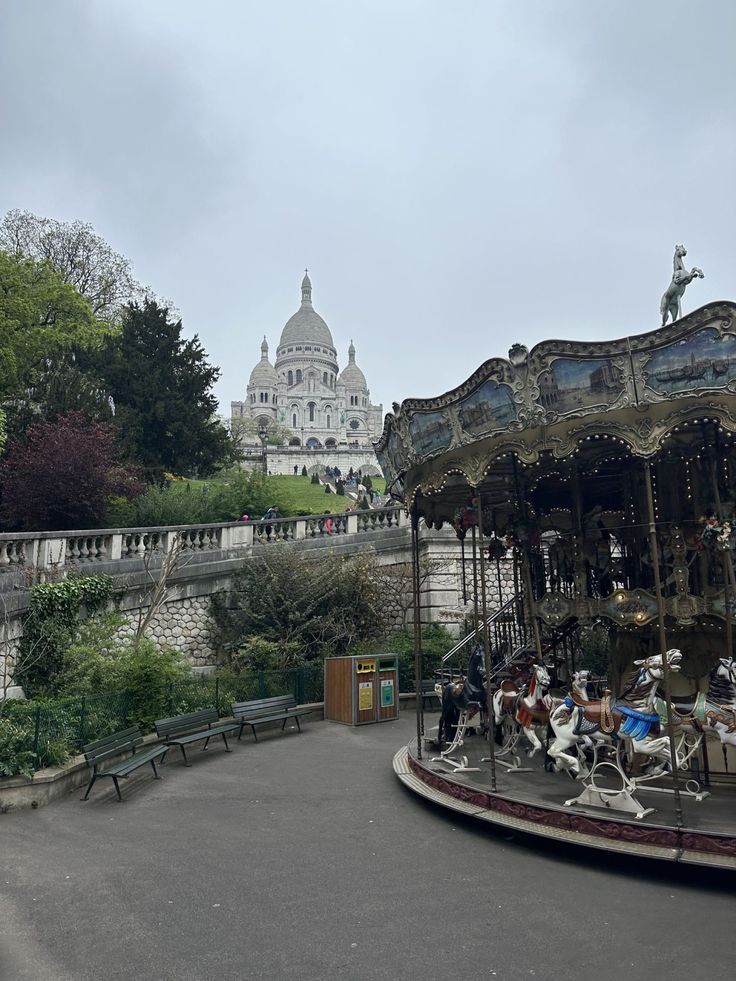 an old fashioned merry go round with people on it