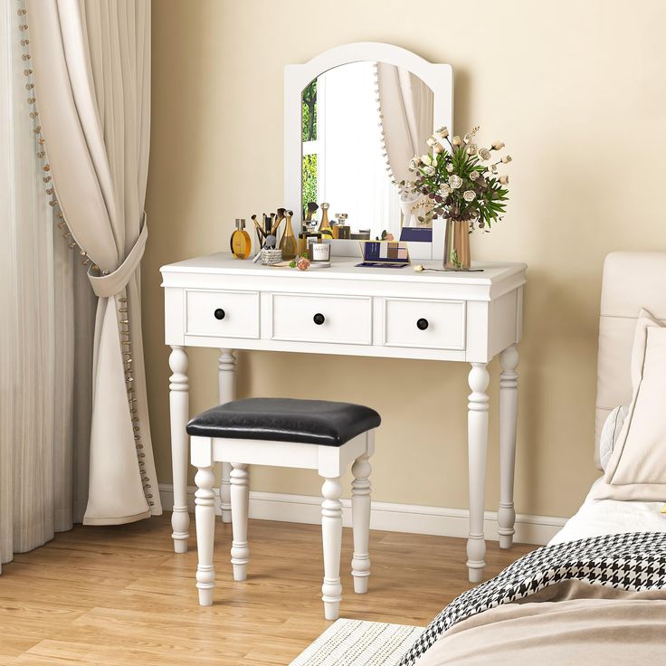 a bedroom with a white vanity table and mirror