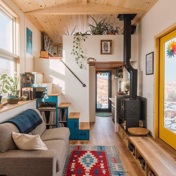 a living room filled with furniture and a wood burning stove top oven next to a window