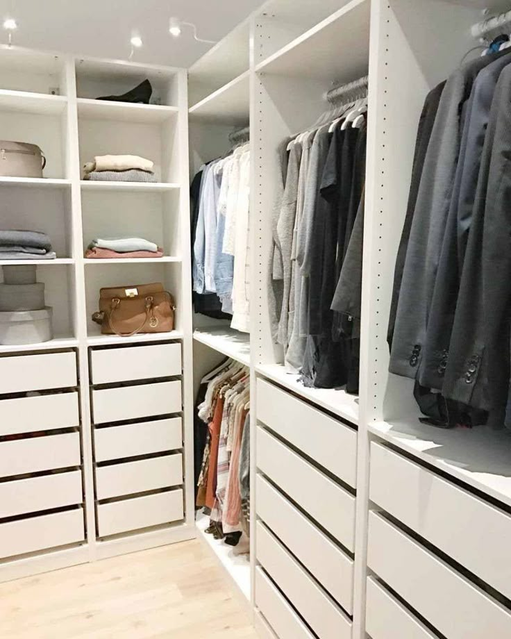 an organized closet with white drawers and shelves