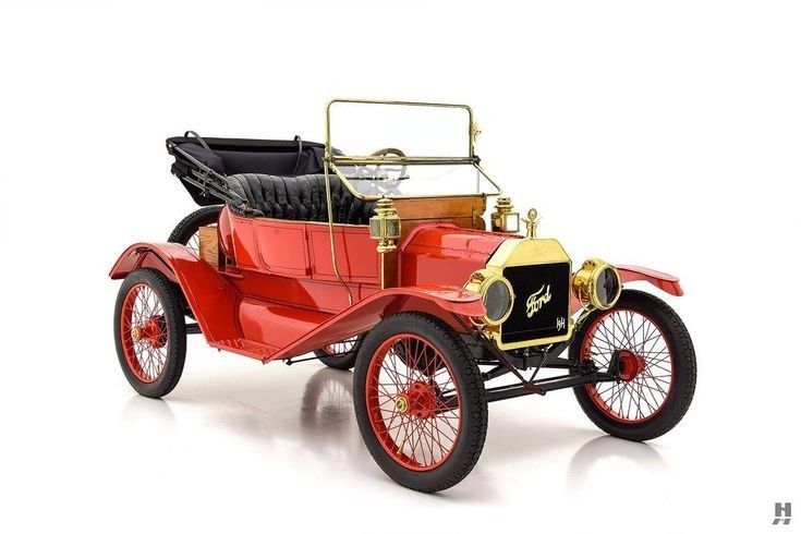 an old fashioned red car on a white background