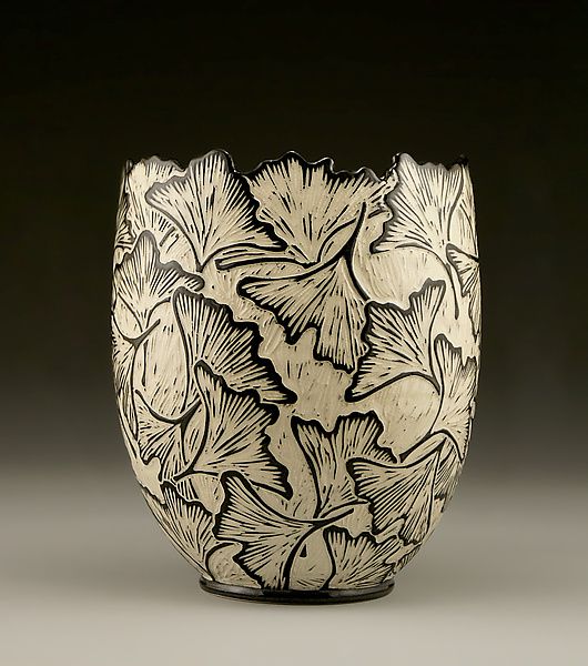 a black and white vase with flowers on it