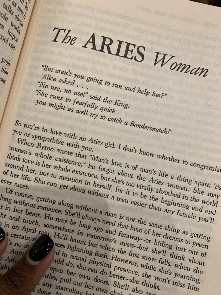 an open book with the words the aries woman written on it and a person's hand resting on one of the pages