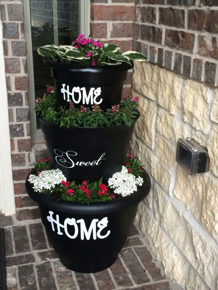 three tiered planters are decorated with flowers and the words smoth on them