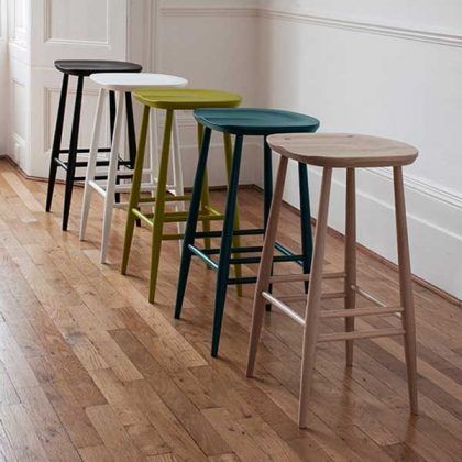 four stools are lined up in a row on the floor next to each other