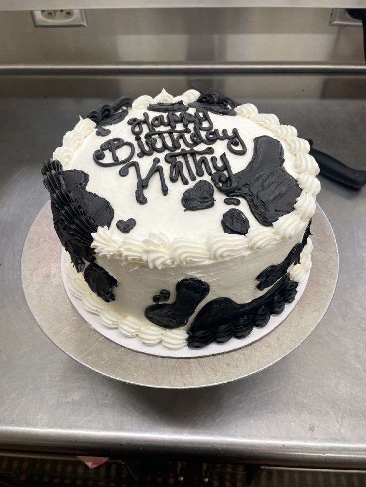 a birthday cake with black and white frosting