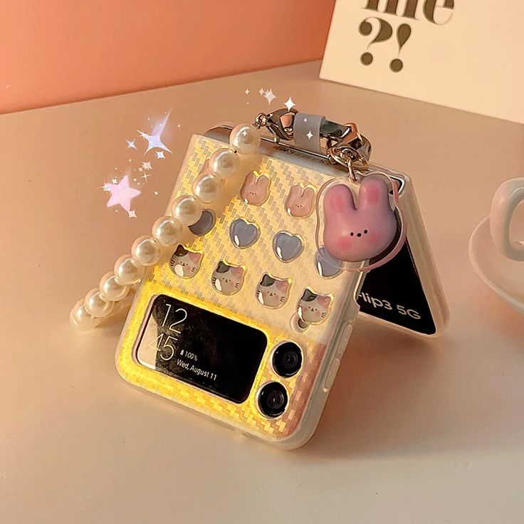 a cell phone case sitting on top of a table next to a cup and saucer