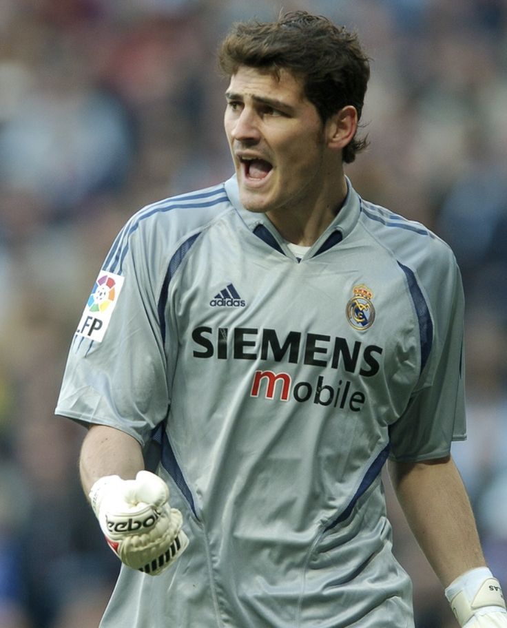 a soccer player with his mouth open and gloves on