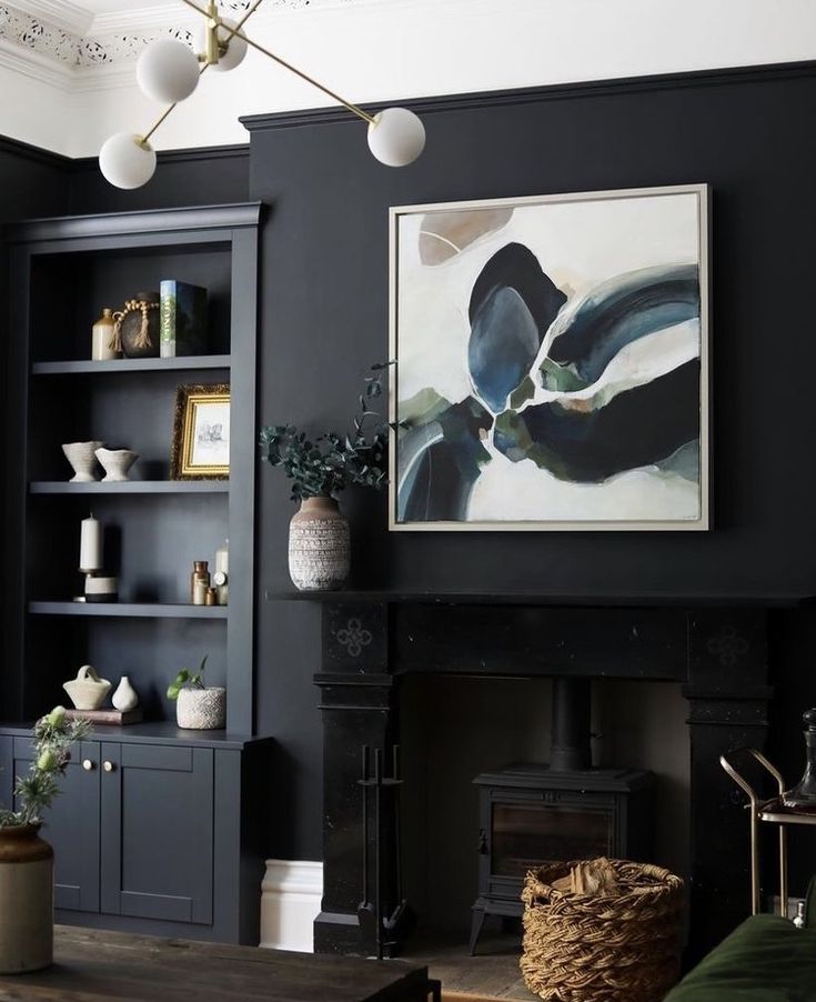 a living room filled with furniture and a painting on the wall over a fire place